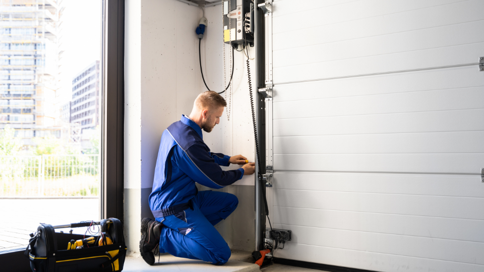 Garage Door Installation And Repair At Home. Contractor Man